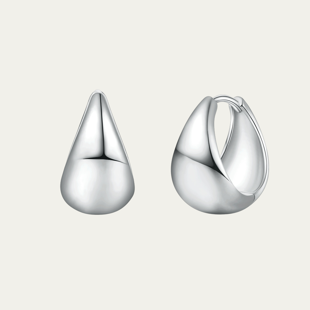 Pair of silver hoop earrings on a light gray background